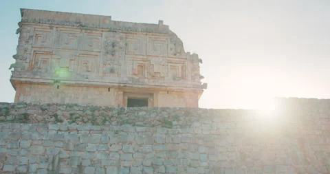 Ancient Mayan ruins square patterned stone building with weathered wall carvings Stock Footage 312175786