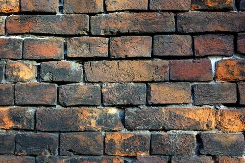 Ancient medieval brick wall, red-black colored brickwork Stock Photos