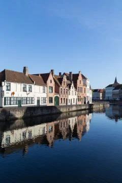 Ancient Medieval Houses near Canal and Water Reflection in Bruges Stock Photos