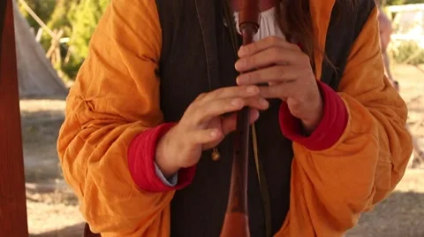Ancient Medieval Man is Playing on the Old Flute During Historical Reenactment Stock Footage 58443290