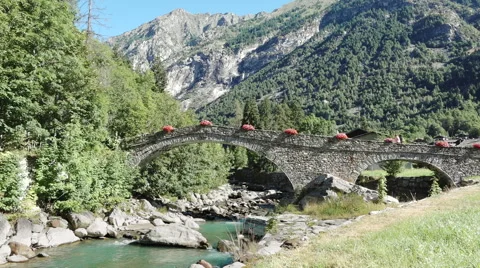 Ancient medieval stone arch bridge, mountain and river, travel Italy Stock Footage 67490716