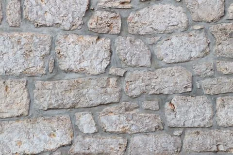 Ancient medieval stone masonry. Texture of a fragment of a wall of an old str Stock Photos