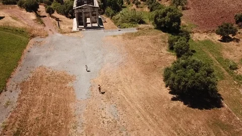 Ancient Messini - drone flight over tourists walking and over grave Stock Footage 113426828