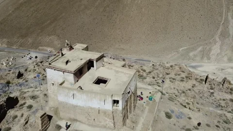 Ancient Monastery Perched on Rocky Cliffside in Remote Himalayan Village wi.. Stock Footage 345730600