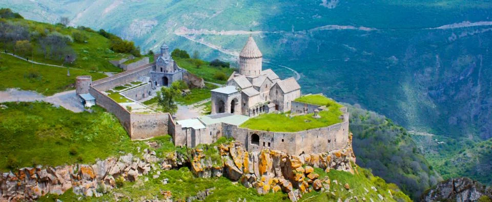Ancient monastery in setting sun. Tatev. Armenia Stock Photos