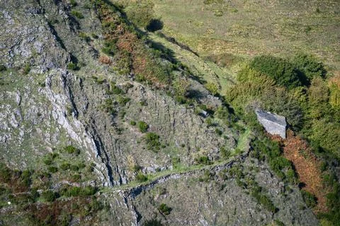 An ancient mountain path leads to an old country house Stock Photos