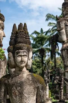 Ancient multi-headed deity statue in buddha park laos Stock Photos