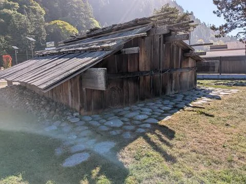 An ancient Native American house with a tiny round doorway Stock Photos