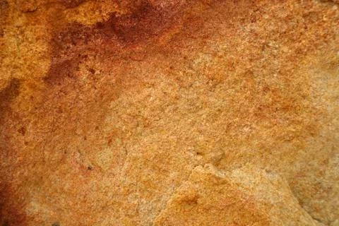 Ancient orange granite stone surface of cave for interior Stock Photos