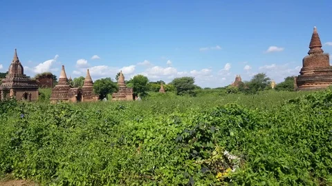 Ancient pagodas spread in midst of grass field, Bagan landscape, sky, Myanmar 스톡 동영상 78883748