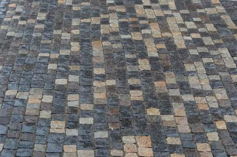 Ancient paving stones made of rectangular stone bricks. Textured background Stock Photos