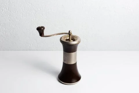 Ancient pepper mill on white background. Stock Photos