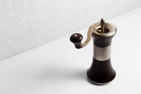 Ancient pepper mill on white background. Stock Photos