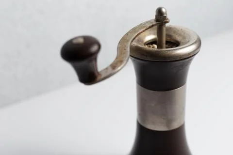 Ancient pepper mill on white background. Stock Photos