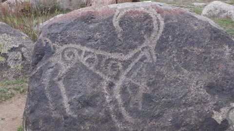 Ancient petroglyph on the stone. Cholpon Ata, Issyk-Kul, Kyrgyzstan Stock Footage 63611986