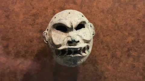 Ancient pre-Hispanic clay mask at the National Museum of Anthropology in Mexico Stockbeeldmateriaal 333692880