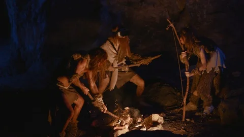 Ancient primitive family of neanderthals using modern VR glasses having fun on Stock Footage