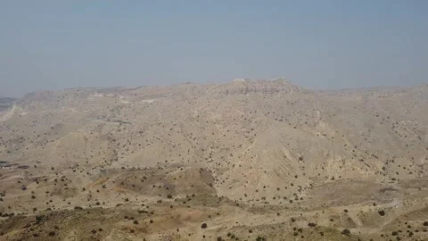 Ancient Ranikot Fort reveals massive walls across a rugged mountain landscape 스톡 동영상 345717249