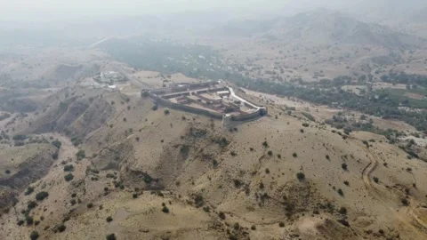 Ancient Ranikot Fort reveals massive walls across a rugged mountain landscape 스톡 동영상 345717250