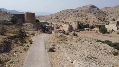 Ancient Ranikot Fort reveals massive walls across a rugged mountain landscape 스톡 동영상 345717456