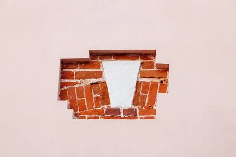 Ancient red brick decorative elements on the pink plastered wall. Exterior Stock Photos
