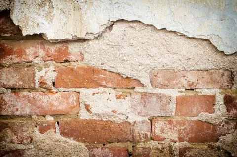 Ancient red brick wall with remaining plaster spots; texture; background Stock Photos