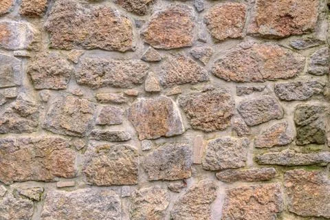 Ancient red stone wall flat background closeup Stock Photos