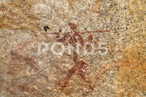 Ancient rock art of painting depicting a human carrying a spear, at Matobo Stock Photos