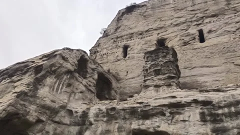 Ancient Rock-Cut Cave Architecture at Yungang Grottoes, Shanxi China Stock Footage 340673993