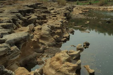 Ancient Rock Formations by a Riverbed Stock Photos