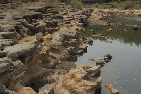 Ancient Rock Formations by a Riverbed Stock Photos
