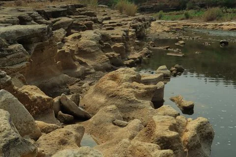Ancient Rock Formations by a Riverbed Stock Photos