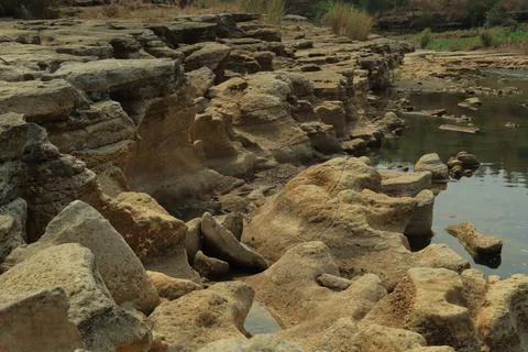 Ancient Rock Formations by a Riverbed Stock Photos