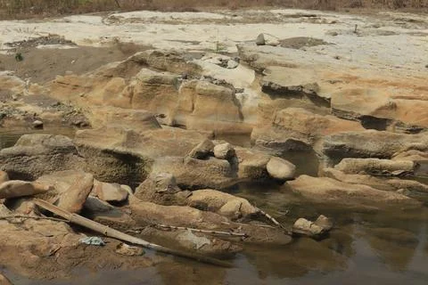 Ancient Rock Formations by a Riverbed Stock Photos