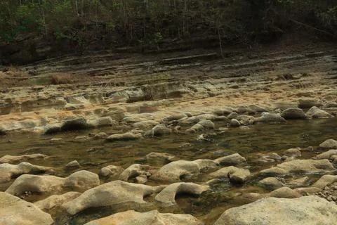 Ancient Rock Formations by a Riverbed Stock Photos
