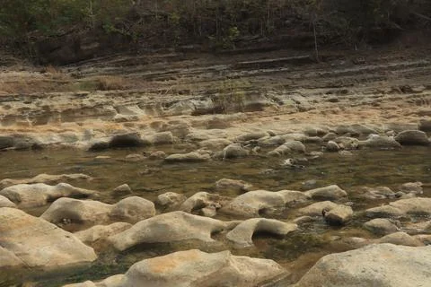 Ancient Rock Formations by a Riverbed Stock Photos