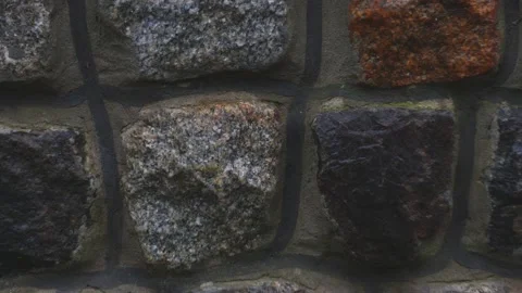 Ancient rock wall ruins made of grey stacked stones - close up tracking shot Vídeo Stock 227873443