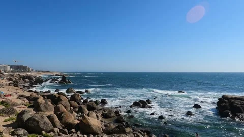 Ancient rocks on the beach basking in the summer sun at Porto, Portugal Stock Footage 282255375