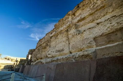 Ancient rocky cliff under clear blue sky Stock Photos