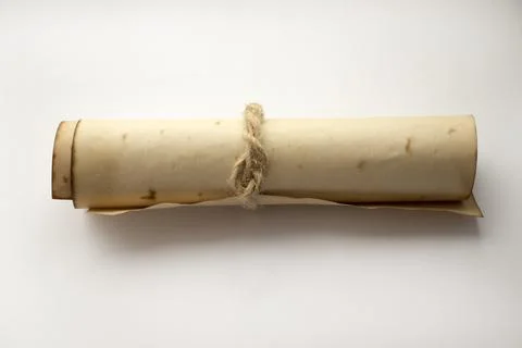 Ancient rolled up parchment paper scroll, insulated on a white background, ti Stock Photos