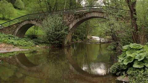 Ancient Roman bridge reflecting in the waters of Arda river in spring. Mogilitsa Stock Footage 59363008