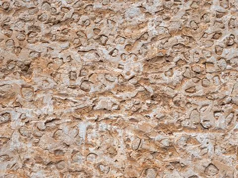 Ancient rough beige stone wall grunge texture Stock Photos