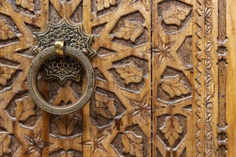 Ancient round copper handle of an old wooden door Stock Photos