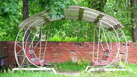 Ancient royal iron swing under a canopy near a red brick wall Stock Footage 73274847