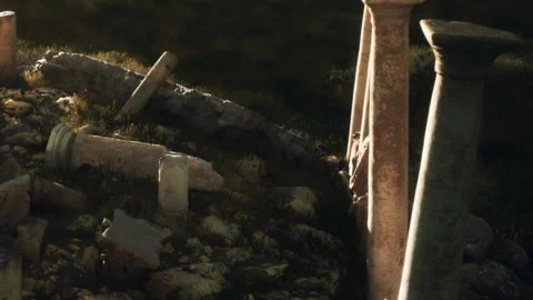 Ancient ruins lie on the ground with broken columns in the sunlight Stock Footage 340986919