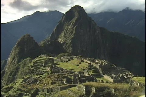 The ancient ruins of Machu Picchu lie in the mountain hillsides of Peru. Stock Footage