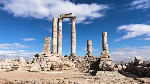 Ancient Ruins Under a Bright Blue Sky with Clouds and Pillars Stock Footage 297432390