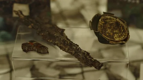 Ancient rusted iron artifacts, including a dagger or sword fragment Stock Footage 339912817