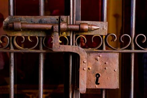 An ancient rusty iron lock with a bolt. Stock Photos