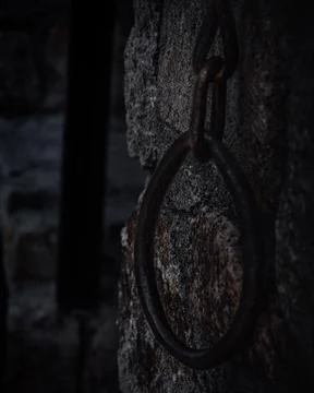 Ancient Rusty Metal Ring on a Dark Castle Wall 스톡 사진